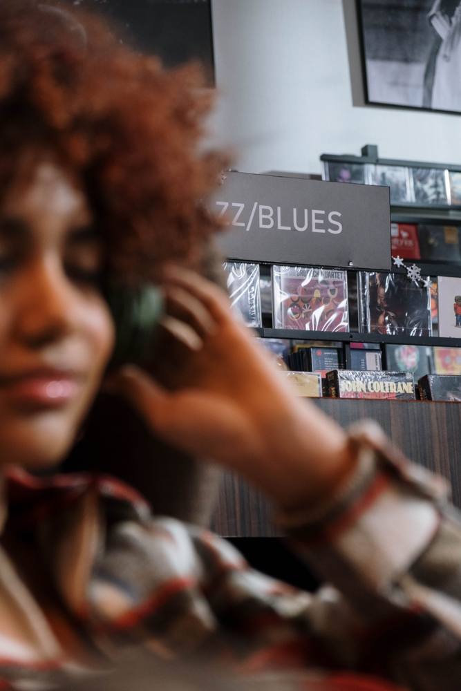Listener with headphones in a record store