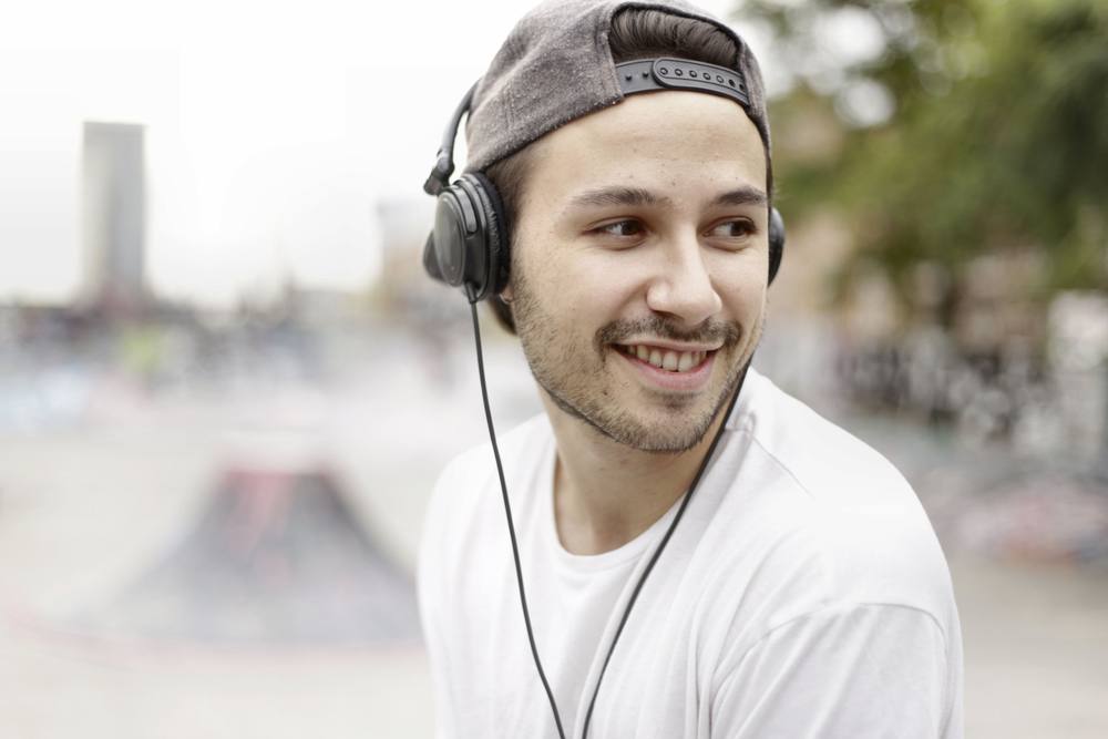 Smiling fan listening to music on headphones