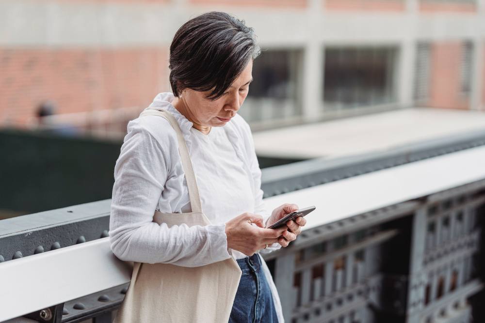 Woman scrolling social media on her phone