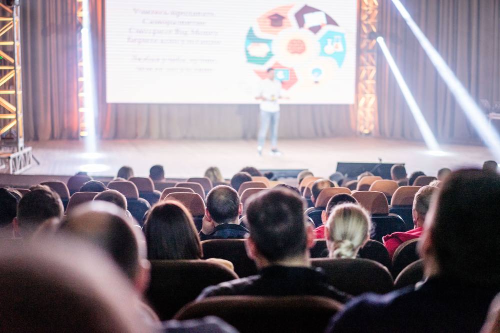Audience at a live workshop in an auditorium